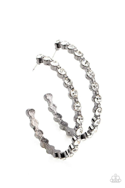 Paparazzi Accessories Royal Reveler - Black Encased in sleek gunmetal fittings, a glamorous collection of glittery white rhinestones delicately coalesce into an oversized hoop for a sparkly statement. Earring attaches to a standard post fitting. Hoop meas