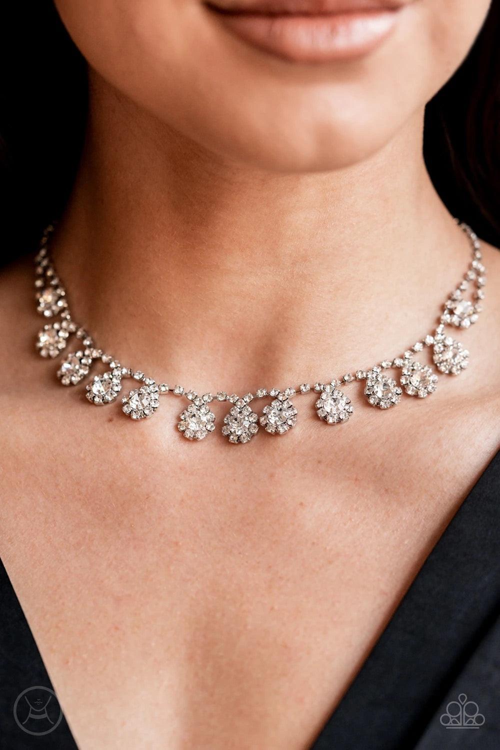 Paparazzi Accessories Princess Prominence - White A dainty strand of glittery white rhinestones encircle solitaire white rhinestones around the neck, creating a glitzy fringe. Features an adjustable clasp closure. Sold as one individual choker necklace. I