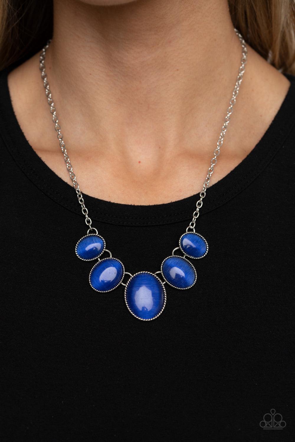 Paparazzi Accessories One Can Only Gleam - Blue Gradually increasing in size, a dainty collection of glowing blue cat's eye oval stones delicately link below the collar for a whimsical pop of color. Features an adjustable clasp closure. Sold as one indivi