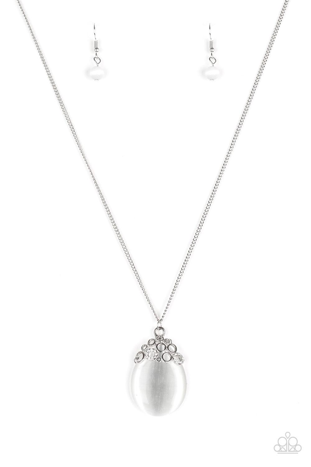 Paparazzi Accessories Nightcap And Gown - White Sporadically dotted in glittery white rhinestones, dainty silver circles join around the top of a glassy white teardrop moonstone. The bubbly pendant swings from the bottom of a lengthened silver chain for a