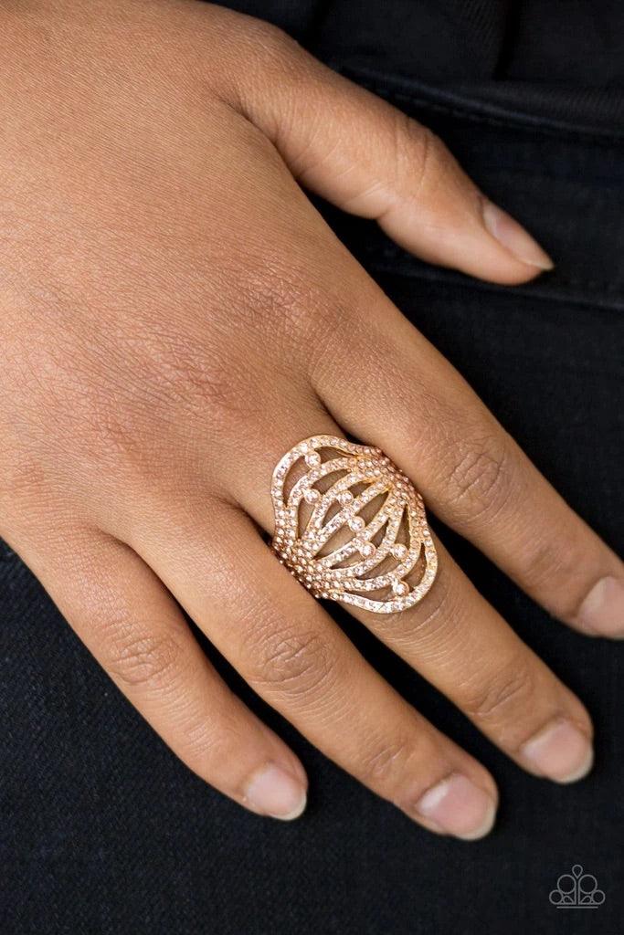 Paparazzi Accessories Stratospheric - Gold Countless dazzling peach rhinestones are sprinkled along swooping gold bands, creating a glamorous frame atop the finger. Features a stretchy band for a flexible fit. Sold as one individual ring. Jewelry