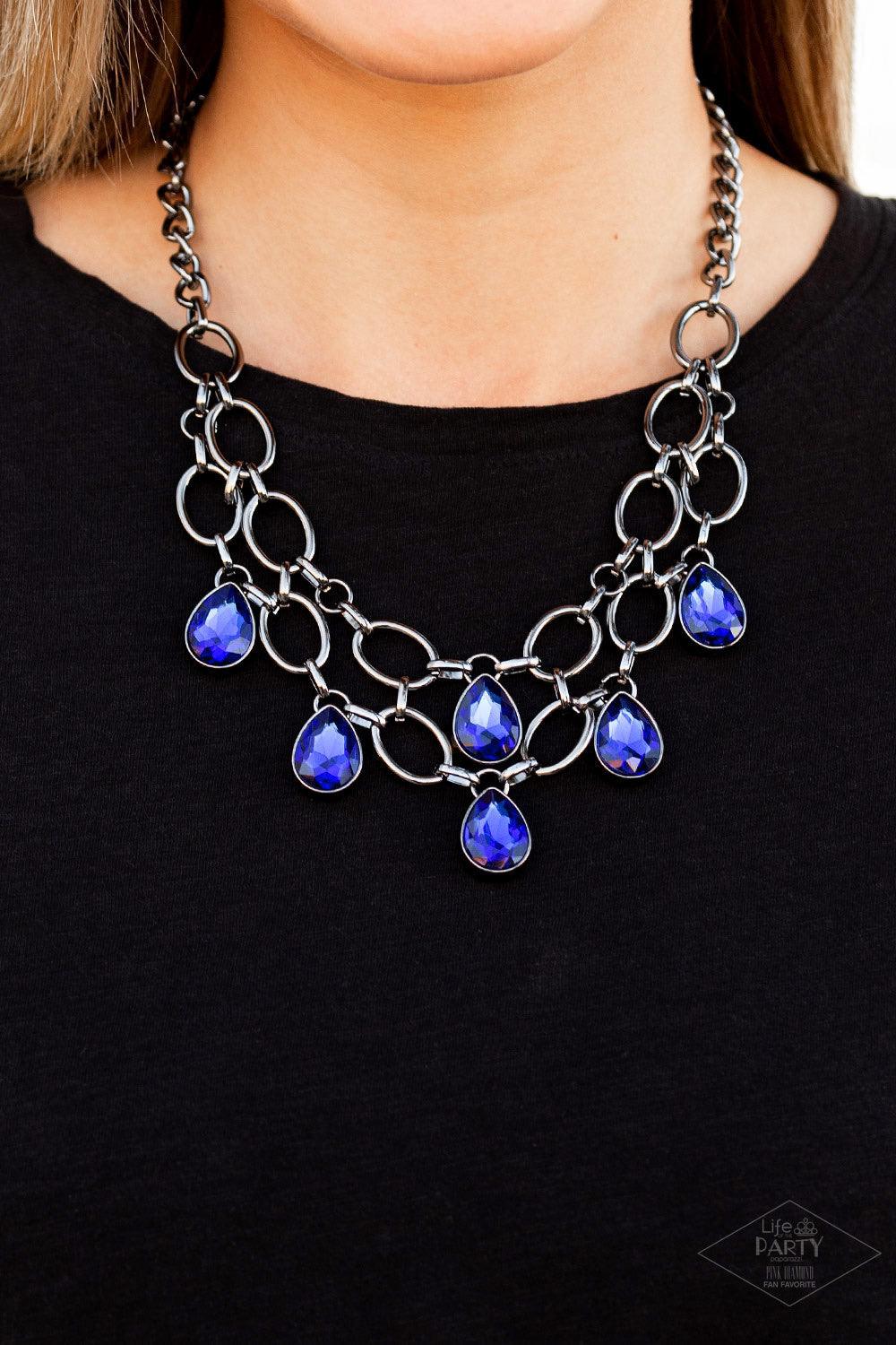 Paparazzi Accessories Show-Stopping Shimmer - Blue Joined by dainty gunmetal links, two rows of dramatic gunmetal chain layer below the collar in a fierce fashion. Glittery blue teardrop gems drip from the glistening layers, adding a timeless shimmer to t