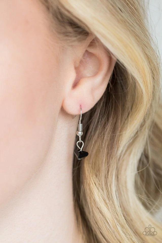Paparazzi Accessories Chicly Geocentric - Black A trio of hexagonal frames swing from the bottom of a lengthened silver chain. A tassel of glassy black pyramidal beads swings from the geometric pendant for an edgy look. Features an adjustable clasp closur