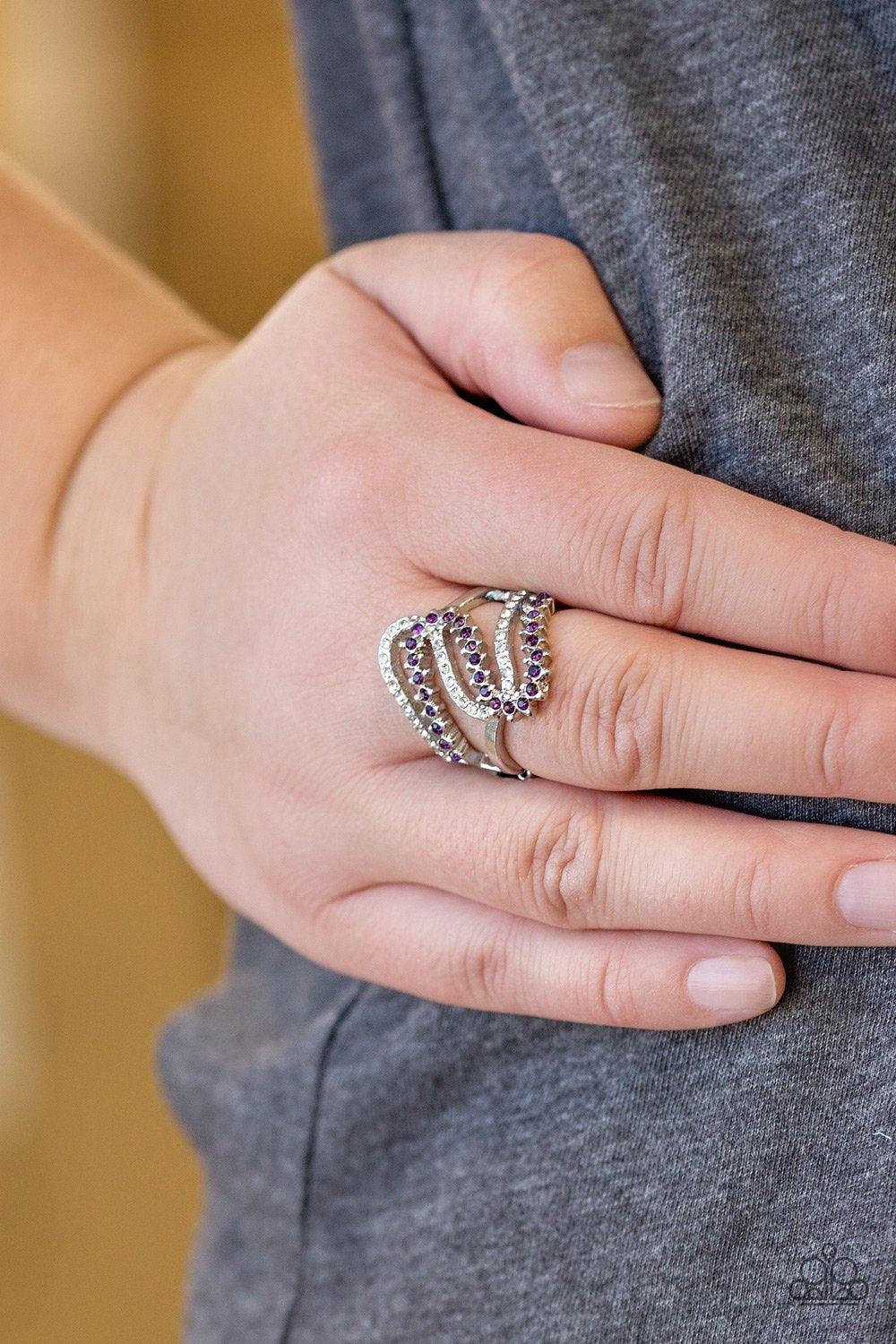 Paparazzi Accessories Make Waves - Purple Encrusted in dainty purple and white rhinestones, radiant silver ribbons wave across the finger, coalescing into a whimsical band. Features a stretchy band for a flexible fit. Sold as one individual ring. Jewelry