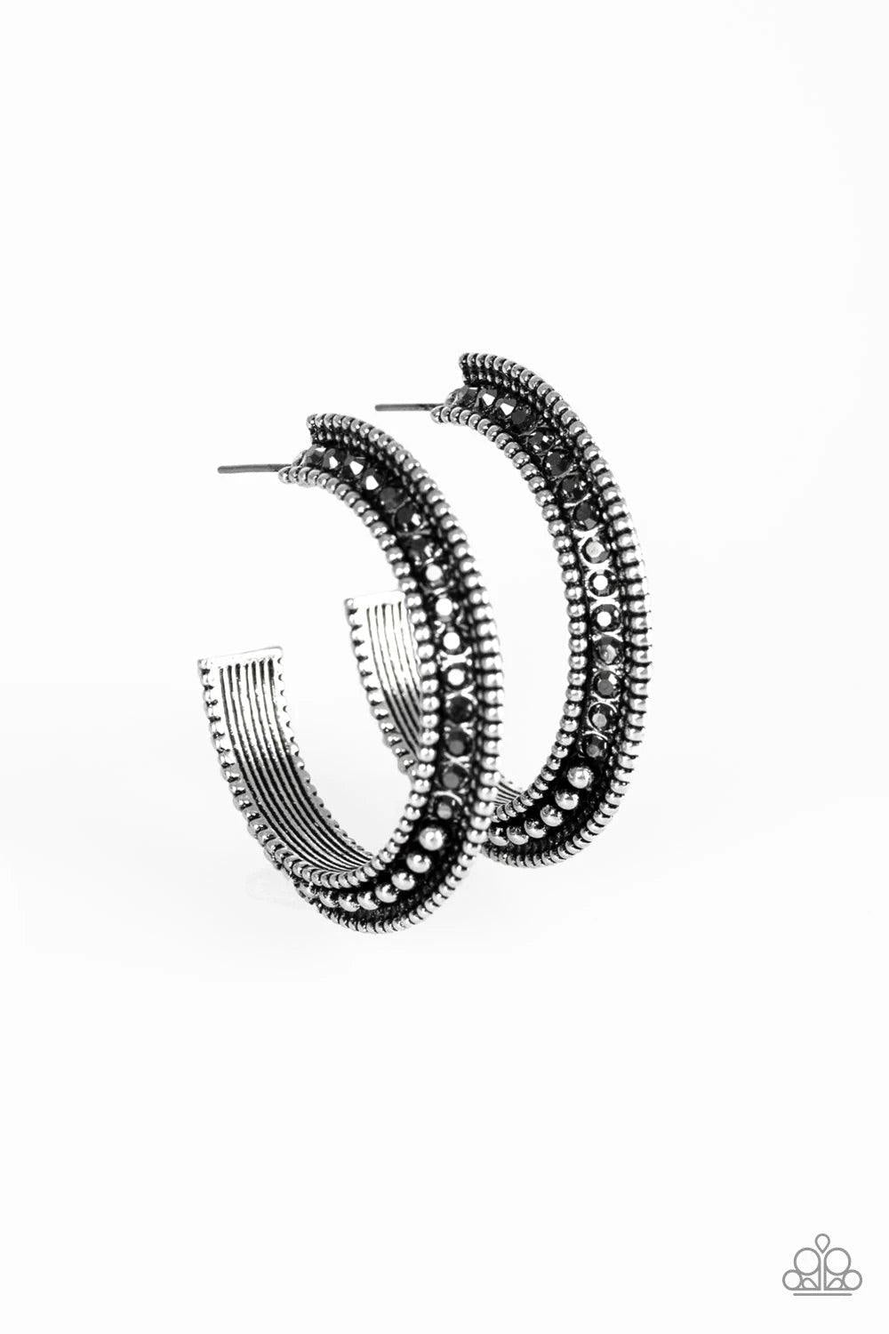 Paparazzi Accessories Retro Reverberation - Silver The top half of a bold silver frame is encrusted in hematite rhinestones, giving way to glistening silver studs for an edgy finish. Earring attaches to a standard post fitting. Hoop measures approximately