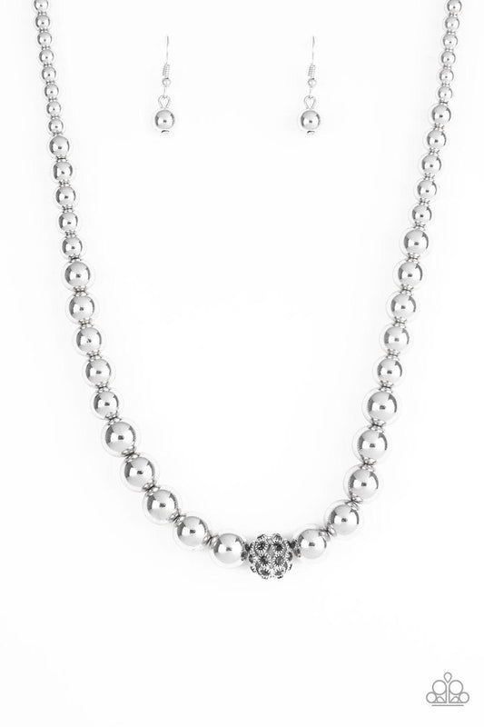 Paparazzi Accessories High-Stakes Fame - Silver Gradually increasing in size near the center, glistening silver beads are threaded along an invisible wire below the collar. Encrusted in smoky rhinestones, a sparkling silver bead adorns the center for a re