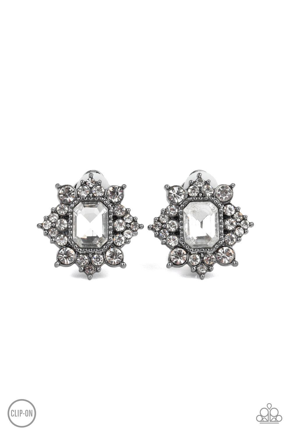 Paparazzi Accessories Interstellar Sparkle - Black *Clip-on Featuring sleek gunmetal fittings, dainty white rhinestones coalesce around a glittery white emerald style rhinestone center for a stellar look. Earring attaches to a standard clip-on fitting. Je