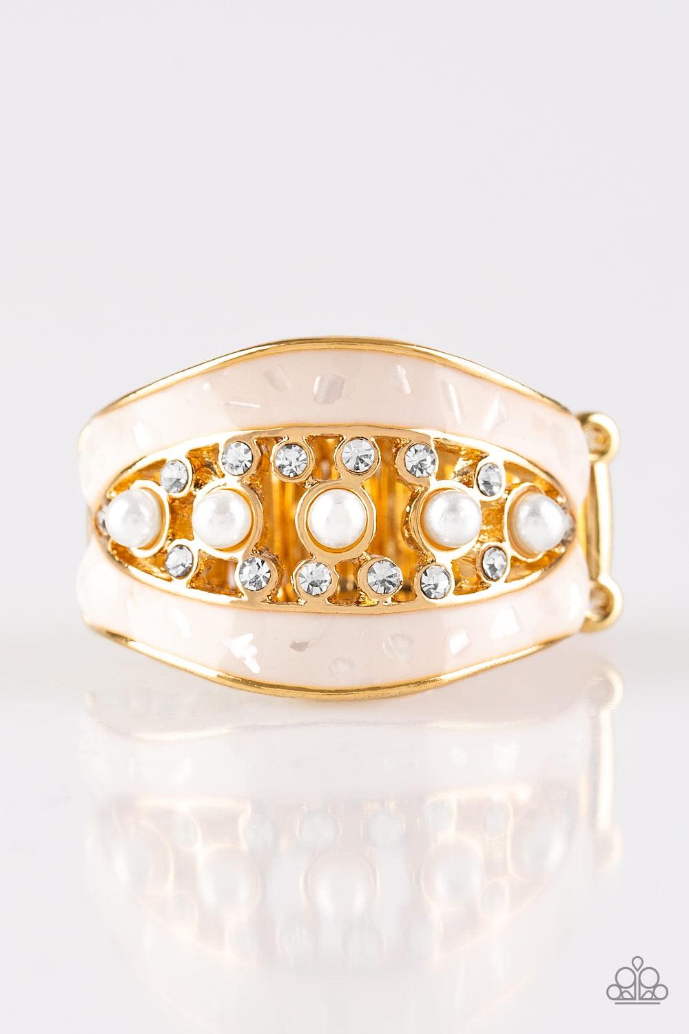 Paparazzi Accessories Royal Treasury - Gold Flecked in shell-like iridescence, shimmery white bands join around a bubbly pearl drop and white rhinestone center for a refined look. Features a stretchy band for a flexible fit. Sold as one individual ring. J