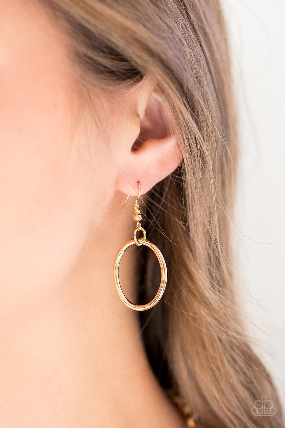 Paparazzi Accessories Elegantly Ensnared - Gold Gradually increasing in size, a collection of bold gold hoops link to a dramatically interconnected chain for a statement-making look. Features an adjustable clasp closure. Jewelry