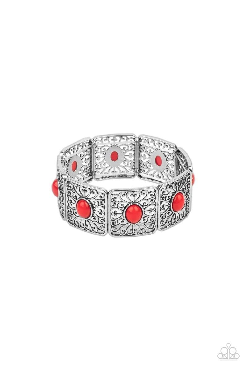 Paparazzi Accessories Cakewalk Dancing - Red A red oval bead is pressed into the center of an airy square frame featuring whimsical heart-shaped and vine-like filigree. The patterned frames are threaded along stretchy bands to repeat around the wrist crea