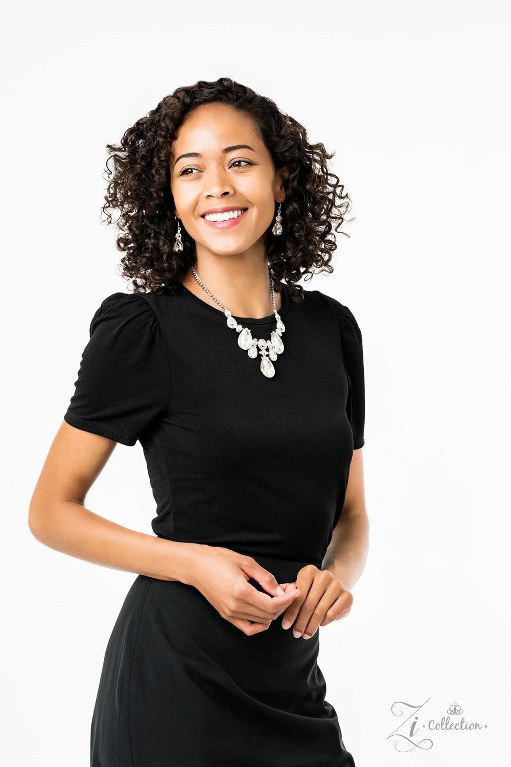 Paparazzi Accessories Reign Dramatic frames featuring tranquil teardrop and classic round white rhinestones delicately link below the collar for a showstopping look. A large teardrop rhinestone drips from the center, creating an unapologetic pendant that