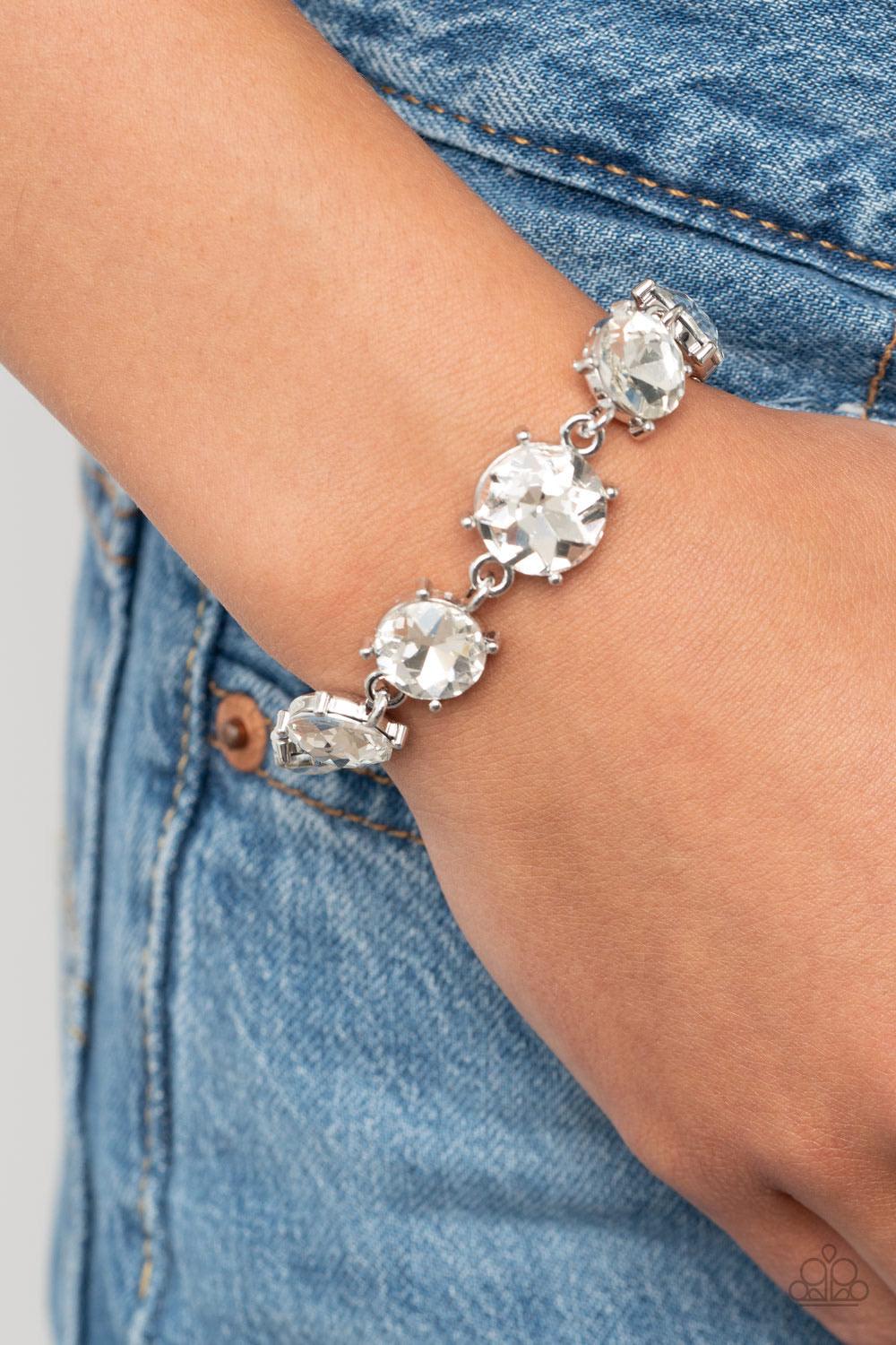Paparazzi Accessories Can’t Believe My ICE - White Gradually increasing in size at the center, a dramatic row of exaggerated white rhinestone encrusted silver frames delicately link around the wrist for a statement-making sparkle. Features an adjustable c