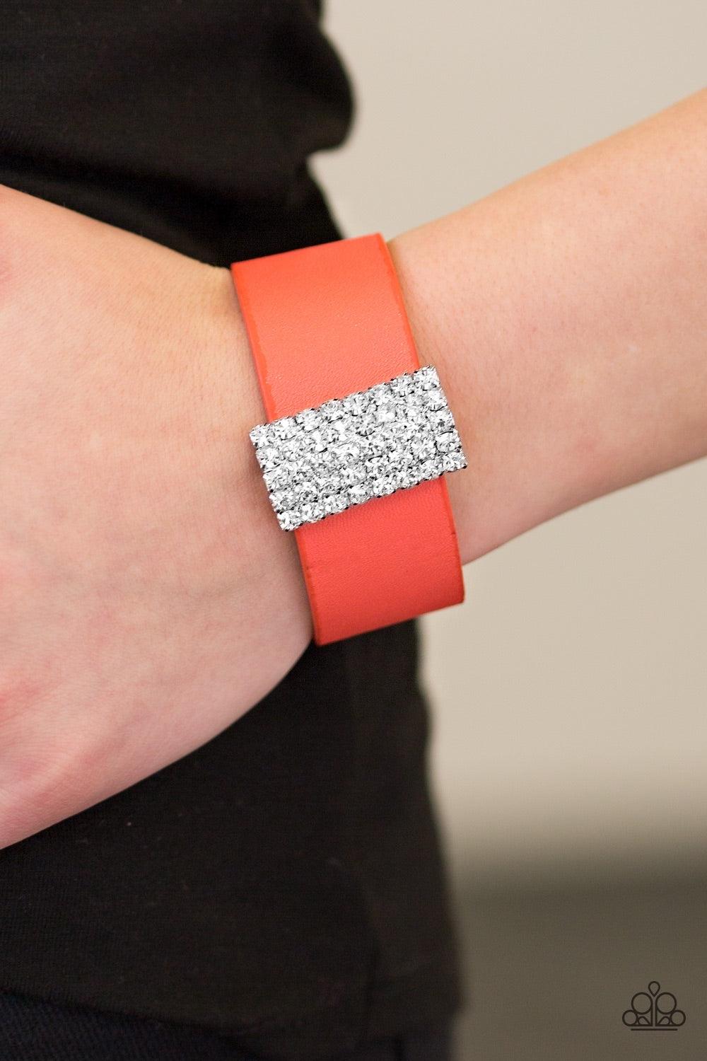 Paparazzi Accessories Walk The CATWALK - Orange Encrusted in glittery white rhinestones, a sparkling frame slides along a strip of coral leather, creating a blinding centerpiece. Features an adjustable snap closure. Jewelry