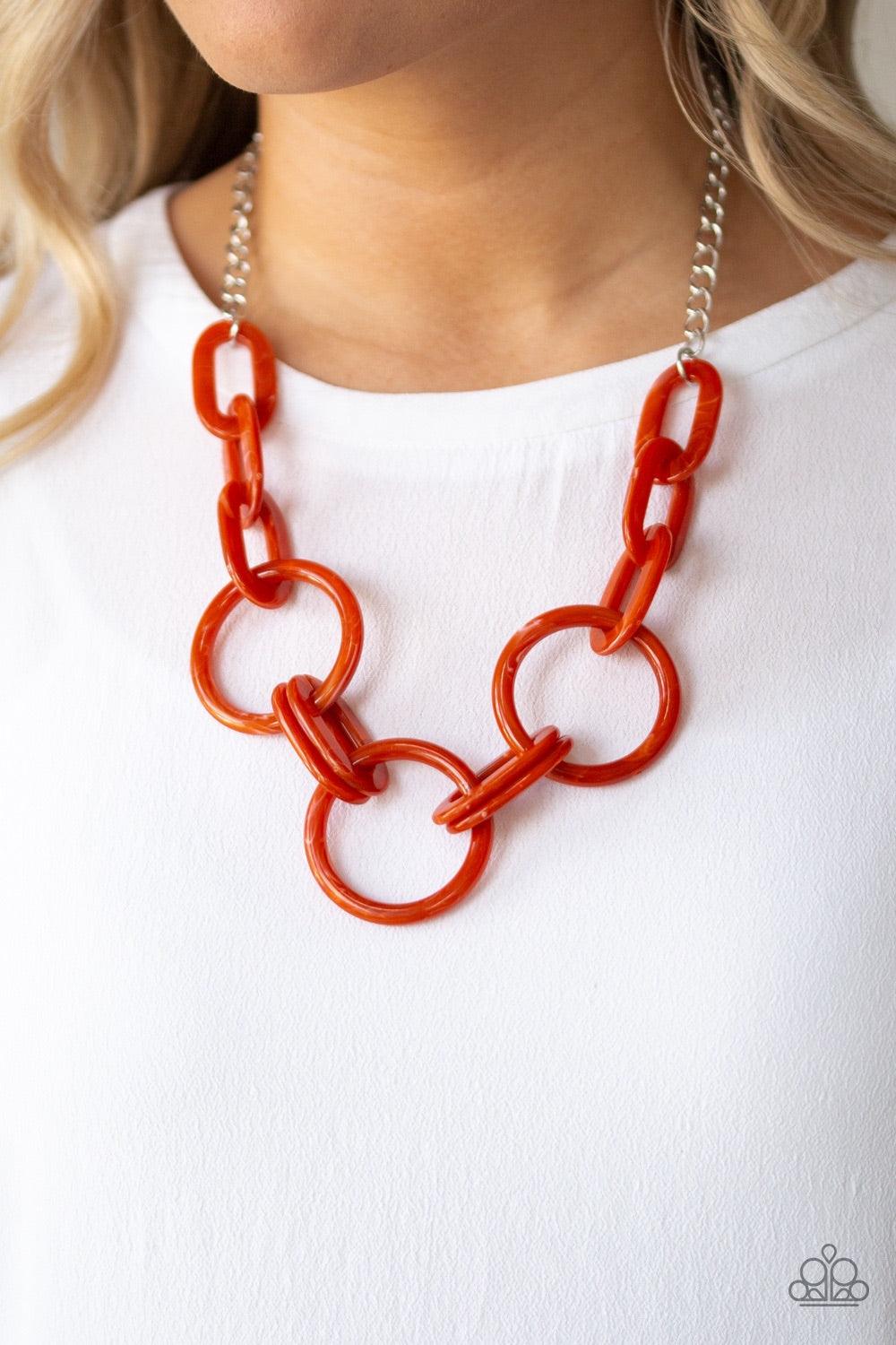 Paparazzi Accessories Turn Up The Heat - Orange Suspended from a shimmery silver chain, a collision of orange acrylic links connect below the collar in a statement-making fashion. Features an adjustable clasp closure. Jewelry