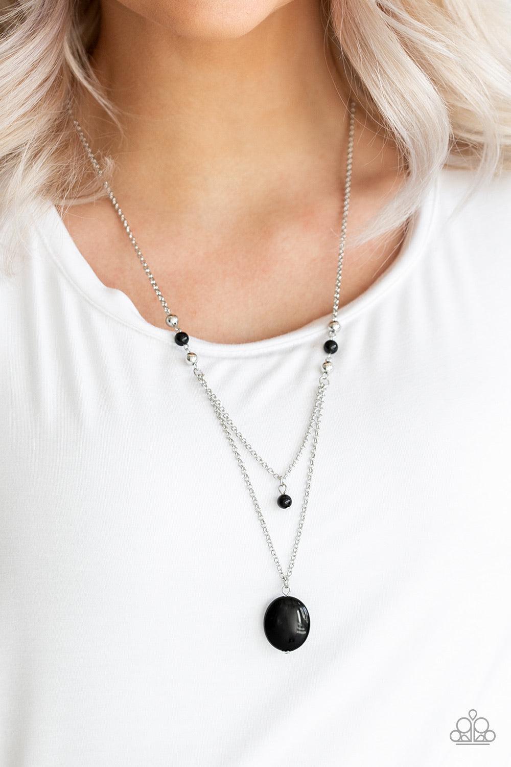 Paparazzi Accessories Time To Hit The ROAM - Black Rows of dainty silver and glassy black beads give way to two shimmery silver chain layers. A dainty black bead swings from the uppermost strand, while a glassy black stone pendant swings from the lowermos