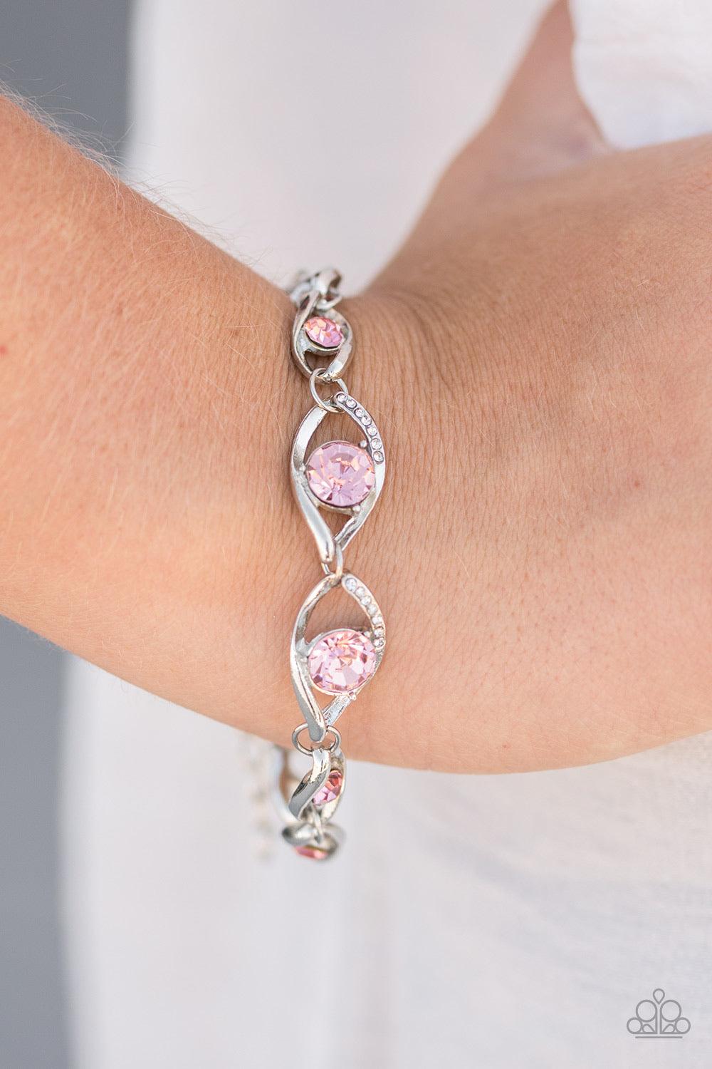 Paparazzi Accessories Rich is Rich - Pink Pink rhinestones are sprinkled along silver marquise-shaped frames, creating a glitzy chain around the wrist. Dazzling pink rhinestones embellish two of the larger silver frames, adding a hint of refined shimmer t
