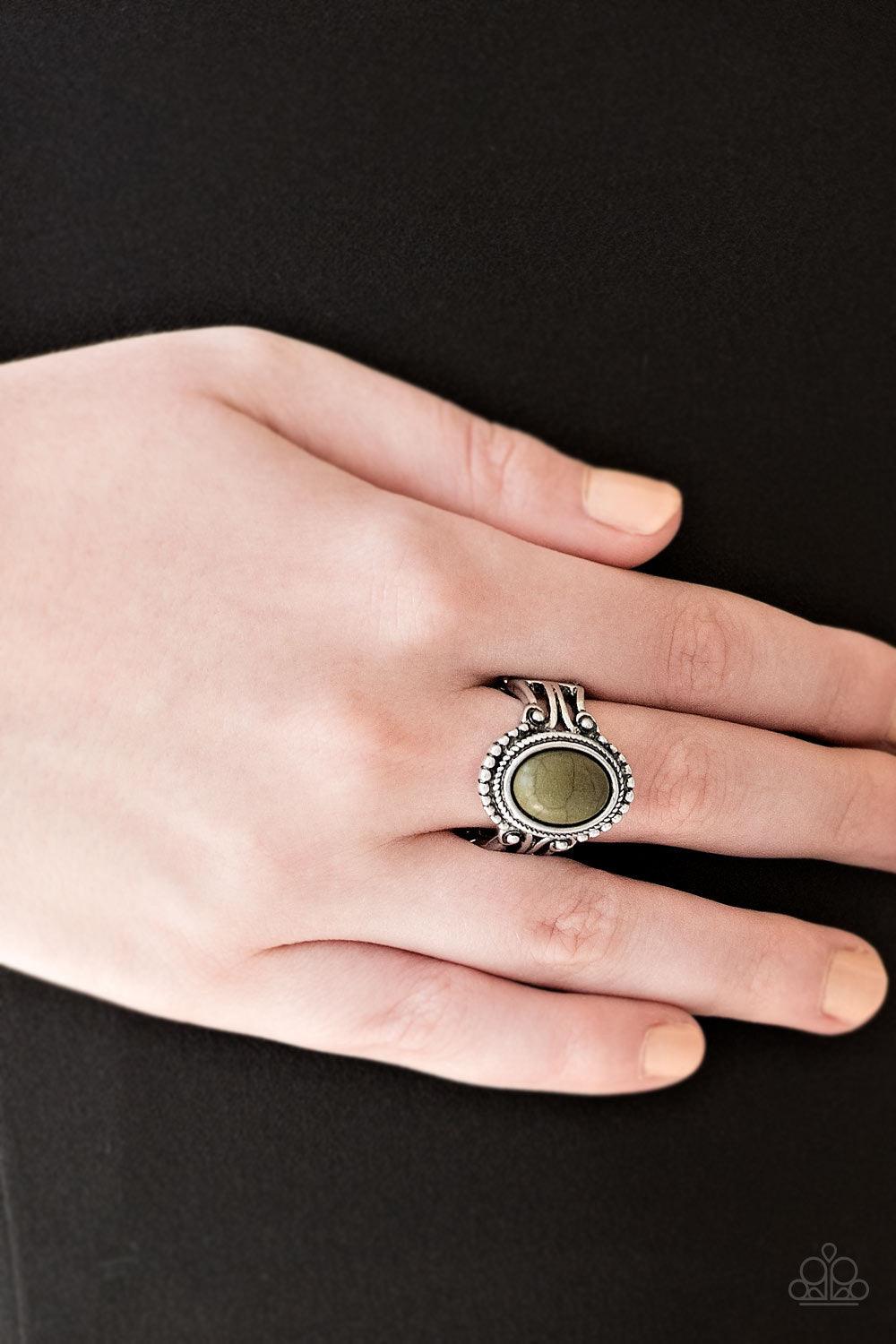Paparazzi Accessories All The Worlds A STAGECOACH - Green An earthy green stone is pressed into the center of a silver band radiating with silver studs for a seasonal look. Features a stretchy band for a flexible fit. Sold as one individual ring. Jewelry