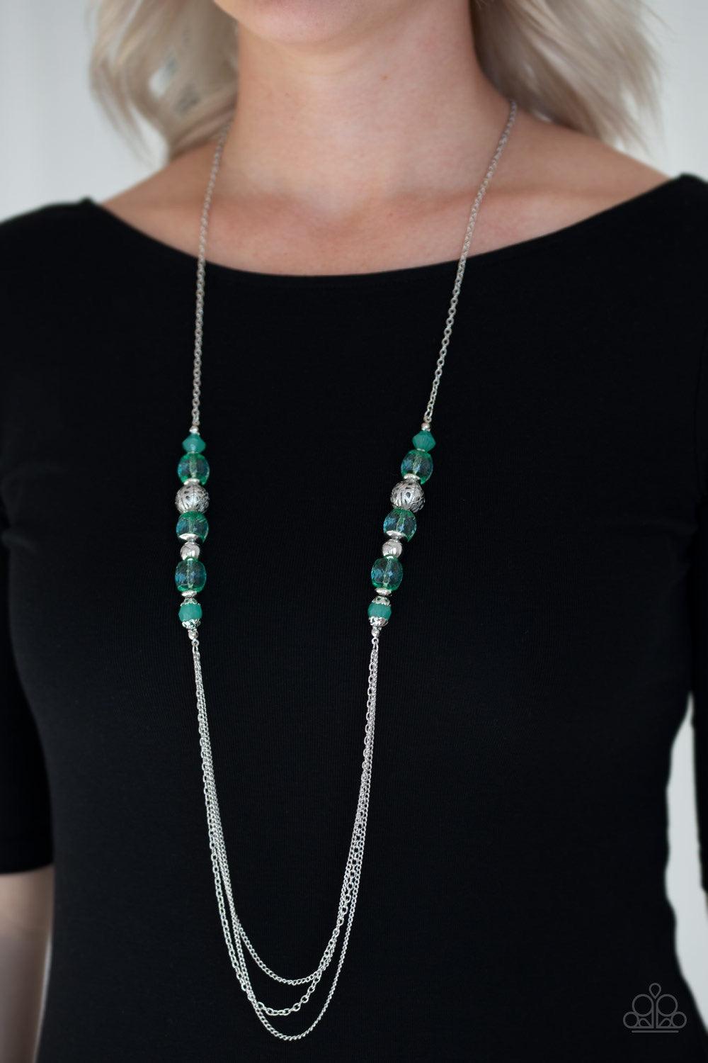Paparazzi Accessories Native New Yorker - Green A collection of ornate silver accents and glassy and opaque green crystal-like beads give way to shimmery silver layers for a refined look. Features an adjustable clasp closure. Jewelry