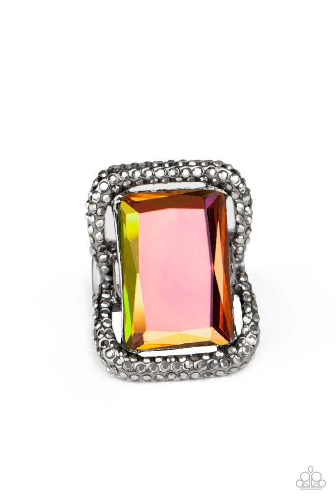 Paparazzi Accessories Deluxe Decadence - Multi Featuring a regal emerald style cut, an oversized oil spill gem nestles inside a rounded square gunmetal frame encrusted in smoky hematite rhinestones for a dramatically glamorous look. Features a stretchy ba