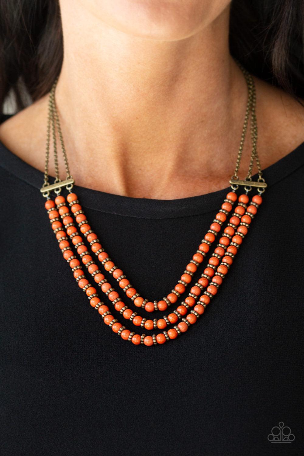 Paparazzi Accessories Terra Trails - Orange Strands of refreshing orange stones and textured brass accents are threaded along invisible wires streaming from the bottom of dainty brass chains, creating earthy layers below the collar. Features an adjustable