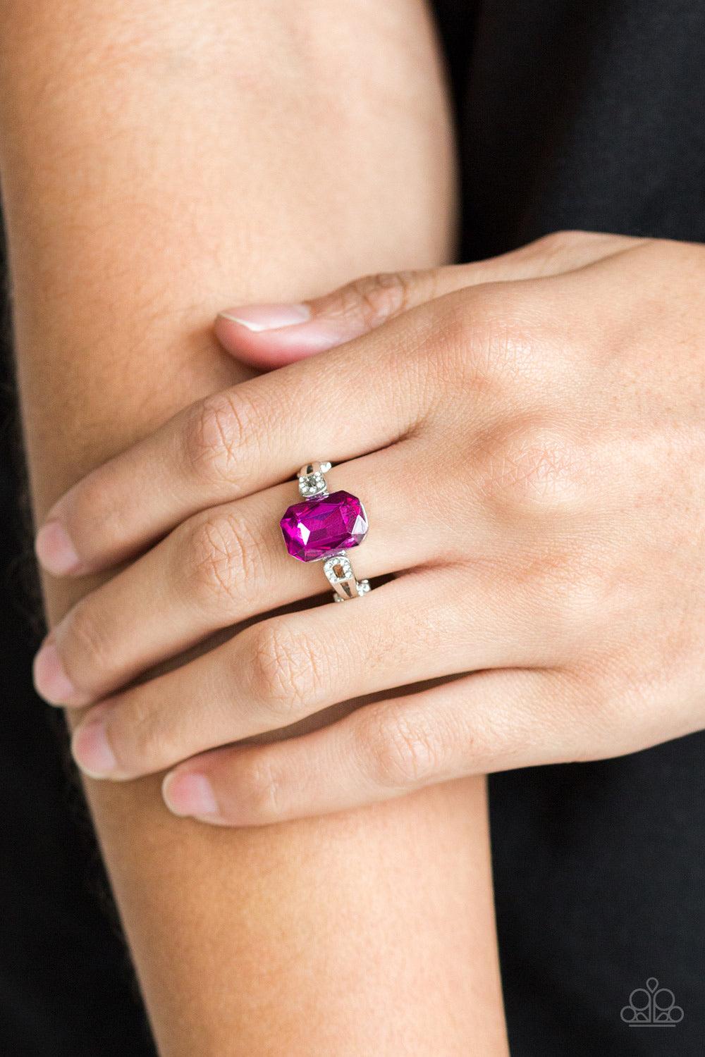Paparazzi Accessories Feast Your Eyes - Pink Featuring a regal emerald style cut, a glittery pink gem is pressed into a dainty silver band dusted in glassy white rhinestones for a refined finish. Features a dainty stretchy band. Jewelry