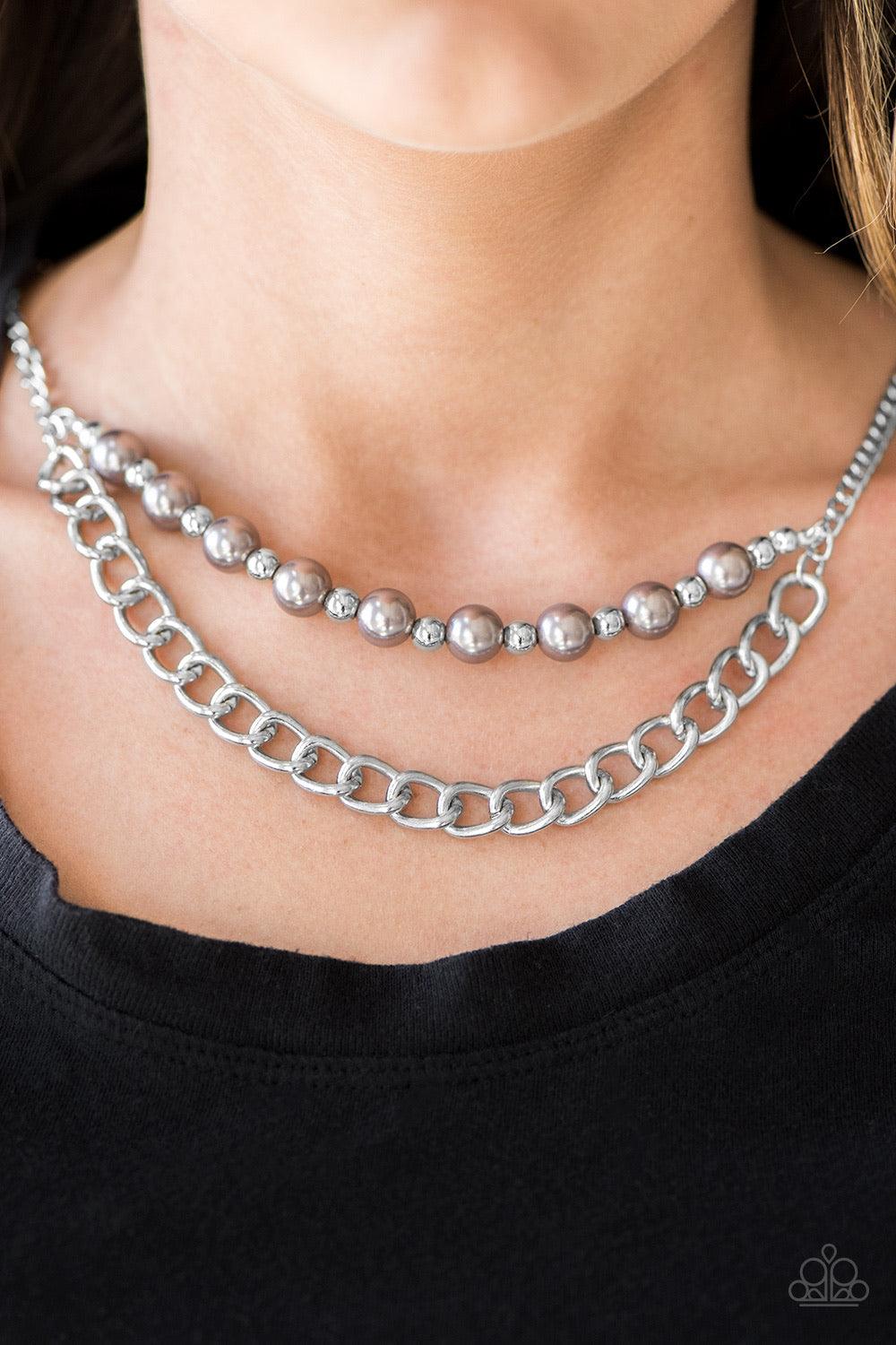 Paparazzi Accessories Glam And Grind - Silver Pearly silver and classic silver beads are threaded along a skinny wire. The pearly beading gives way to a bold strand of silver chain, creating edgy layers below the collar. Features an adjustable clasp closu
