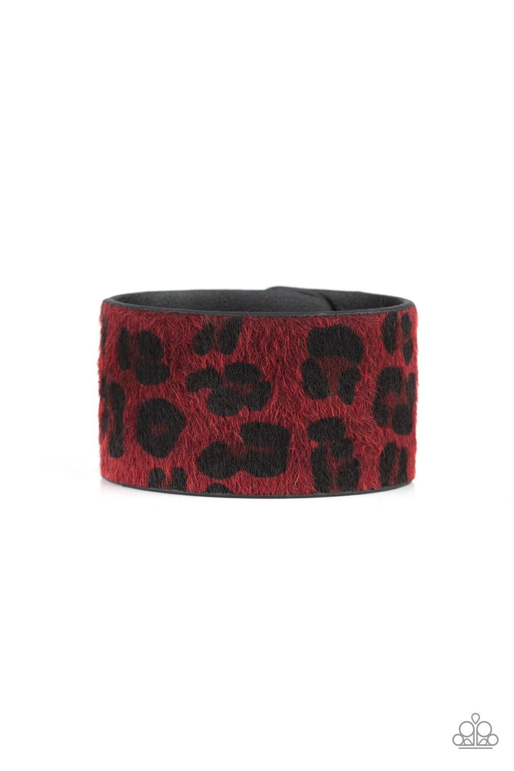 Paparazzi Accessories Cheetah Cabana - Red A fuzzy red cheetah pattern is printed across the front of a thick black leather band for a wild look. Features an adjustable snap closure. Jewelry