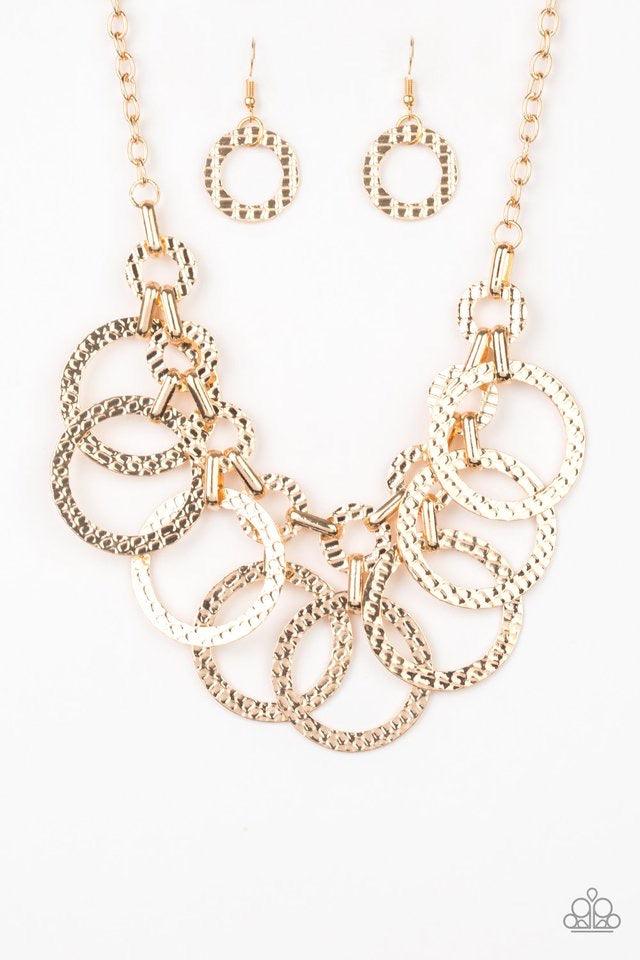 Paparazzi Accessories Jammin Jungle - Gold Hammered gold hoops swing from the bottom of interconnected hammered links, creating an edgy industrial fringe below the collar. Features an adjustable clasp closure. Sold as one individual necklace. Includes one