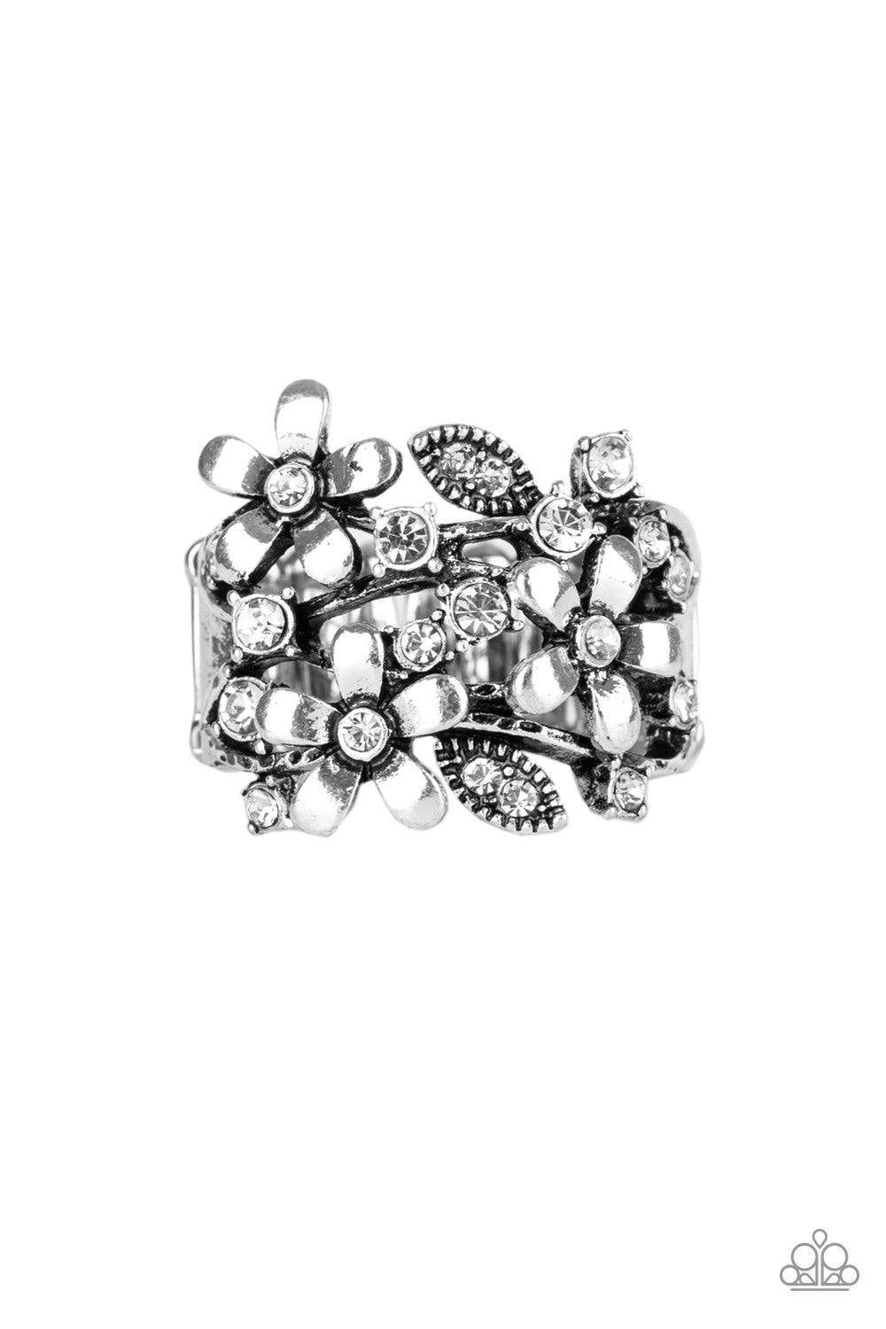Paparazzi Accessories Gardenia Gleam ~White Dotted with glittery white rhinestones, a trio of shimmery silver flowers bloom across the finger, coalescing into a whimsical band. Features a stretchy band for a flexible fit.