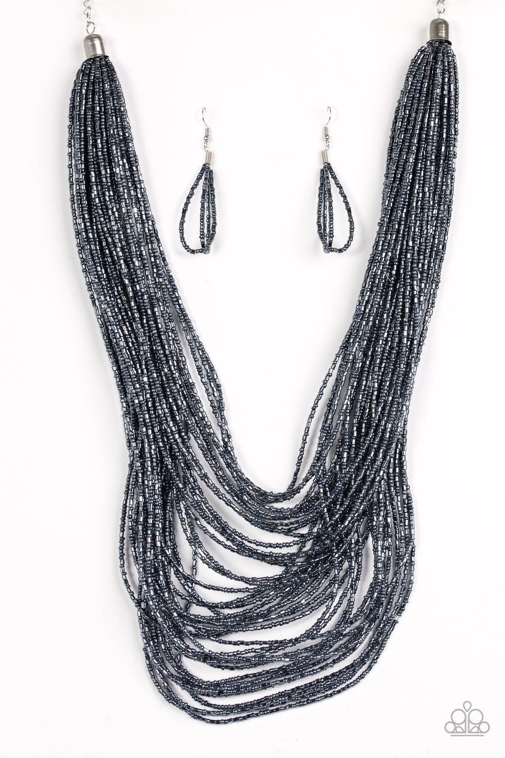 Paparazzi Accessories Ice Storm - Blue Brushed in an icy metallic shimmer, countless strands of blue seed beads drape across the chest in a bold fashion. Featuring a collision of shapes and shimmer, the glittery strands connect to two large silver accents