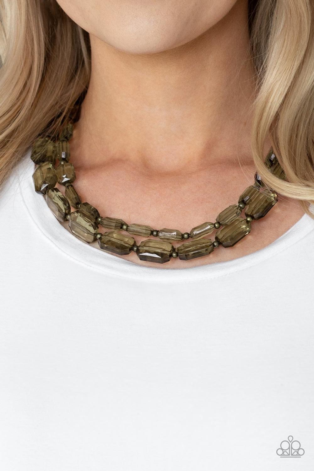Paparazzi Accessories Ice Bank - Brass Infused with dainty brass beads, glassy emerald-cut beads layer below the collar for an edgy look. Features an adjustable clasp closure. Jewelry