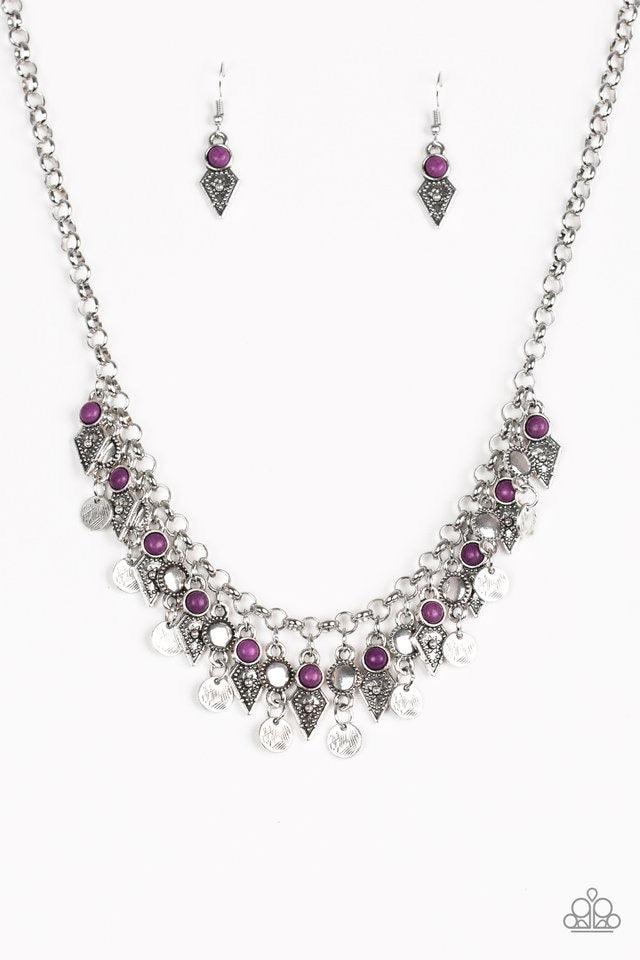 Paparazzi Accessories Jurassic Jamboree - Purple Featuring glassy and polished finishes, round and asymmetrical purple beads trickle from the bottom of a double-linked silver chain. An additional silver chain is layered above the summery beading for a sea