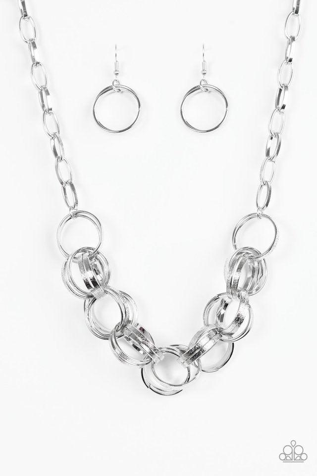 Paparazzi Accessories Statement Made - Silver Etched in light-catching shimmer, glistening silver rings link below the collar, connecting into a bold clustered fringe for a fierce industrial look. Features an adjustable clasp closure. Sold as one individu