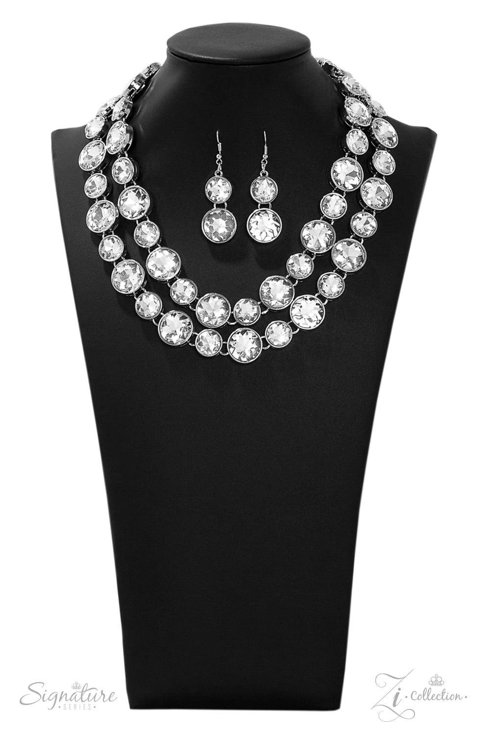 Paparazzi Accessories The Natasha Two rows of dramatically oversized rhinestones sparkle blindingly along the collar. The alternating sizes of the gems give this showstopper some exaggerated depth and dazzle. Features an adjustable clasp closure. 2019 ZiC