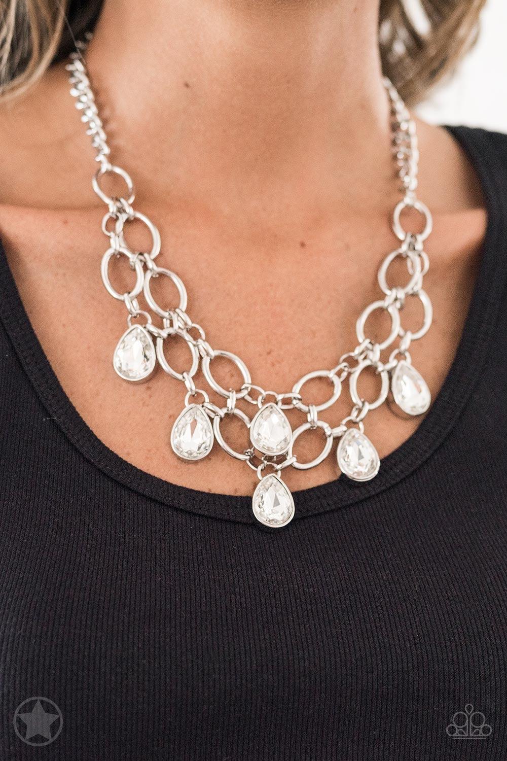 Paparazzi Accessories Show-Stopping Shimmer - White Joined by dainty silver links, two rows of dramatic silver chain layer below the collar in a fierce fashion. Glittery white teardrops drip from the glistening layers, adding a timeless shimmer to the sho
