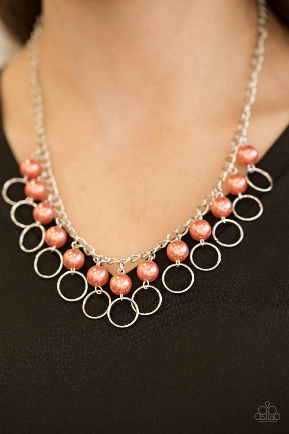 Paparazzi Accessories Run The Show - Orange Classic coral pearls trickle from the bottom of a glistening silver chain. Shimmery silver hoops cascade from the pearls, creating a flirty fringe below the collar. Features an adjustable clasp closure. Sold as
