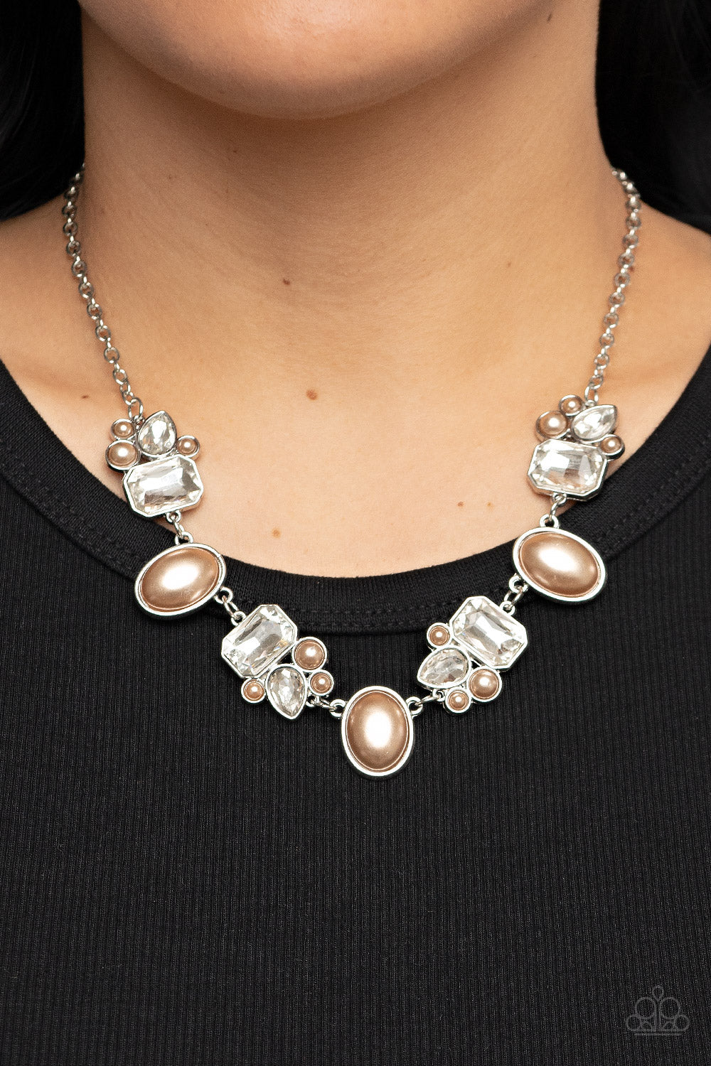 Paparazzi Accessories Sensational Showstopper - Brown Swoon-worthy emerald cut and teardrop rhinestones, accented with bubbly brown pearl beads, coalesce into stunning asymmetrical frames. A trio of elegant brown oval pearl beads alternates with the asymm