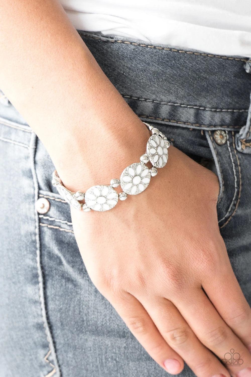 Paparazzi Accessories Dancing Dahlias - White Painted in a refreshing white finish, ornate silver floral frames are threaded along a stretchy band across the wrist for a seasonal look. Sold as one individual bracelet. Jewelry
