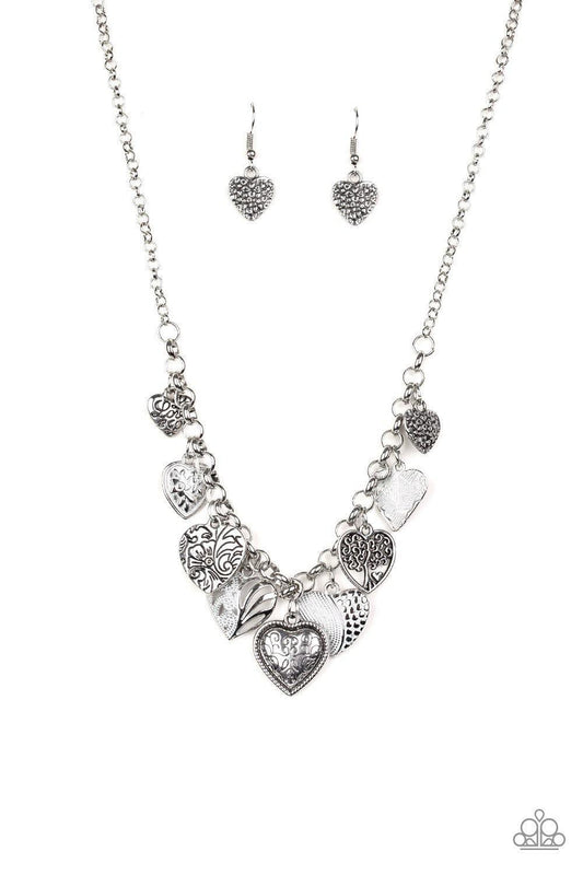 Paparazzi Accessories Grow Love - White Featuring an array of floral patterns, a collection of silver hearts swing from the bottom of a shimmery silver chain. Alternating charms are brushed in a shiny white finish, creating a colorful fringe below the col