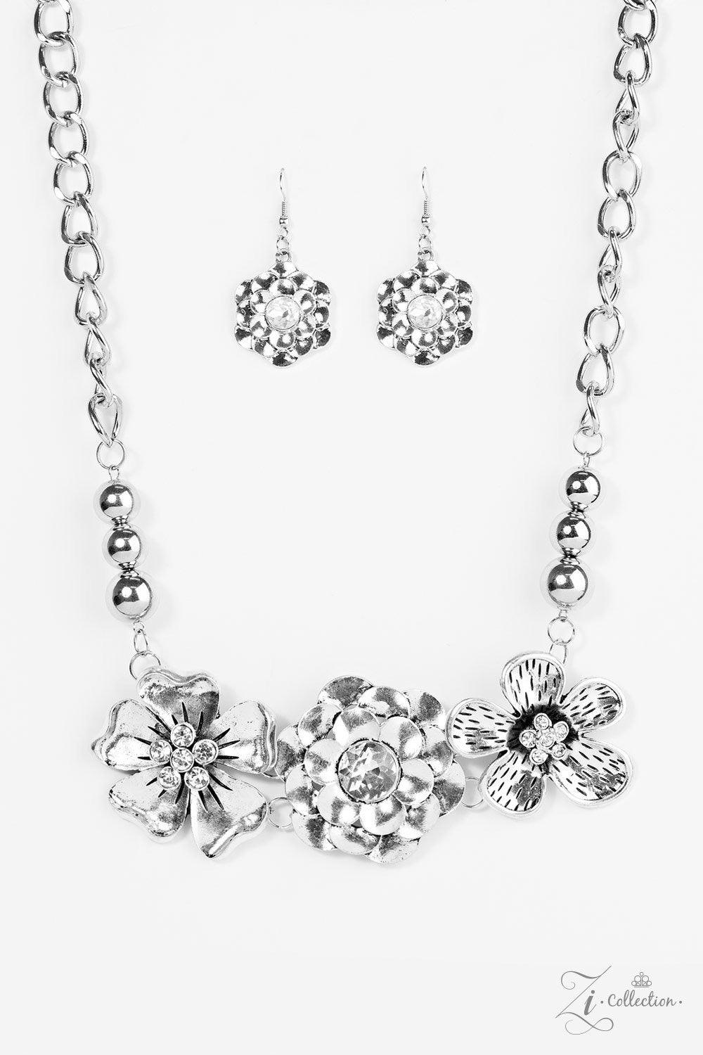 Paparazzi Accessories Abloom Strands of bulky silver chain and polished silver beads give way to three flower frames below the collar. Brushed in lifelike floral detail, the glistening flowers feature glittery rhinestone centerpieces for a timeless finish