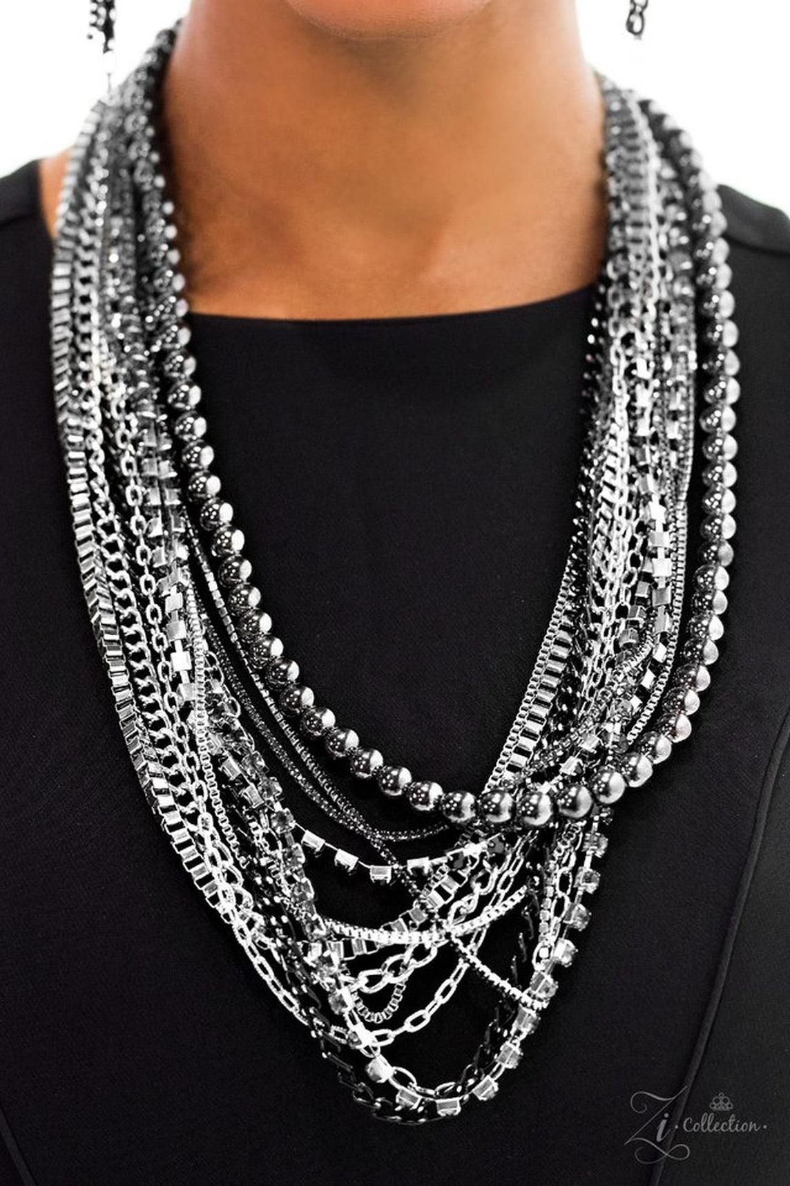 Paparazzi Accessories Epic Rows of glistening gunmetal beads, silver box-chain, and edgy black chain drape into endless layers of shimmer. Infused with rows of classic silver chains, strands of black and smoky rhinestones pressed into square frames drip b