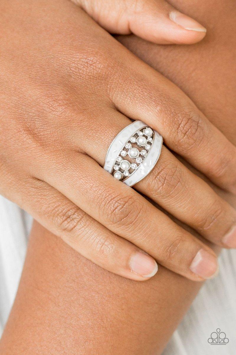 Paparazzi Accessories Royal Treasury - White Flecked in shell-like iridescence, shimmery white bands join around a bubbly pearl drop and white rhinestone center for a refined look. Features a stretchy band for a flexible fit. Sold as one individual ring.
