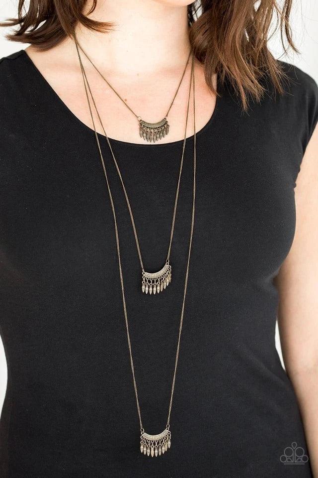 Paparazzi Accessories Seasonal Charm - Brass Infused with beaded brass fringes, floral embossed brass frames layer down the chest in a whimsically stacked fashion. Features an adjustable clasp closure. Jewelry