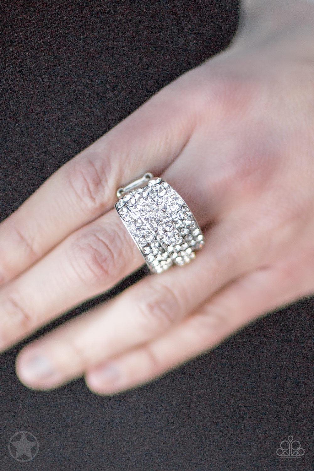 Paparazzi Accessories The Millionaires Club - White Row upon row of glistening white rhinestones stack into an incandescent display. An additional row of sparkling rhinestones wraps diagonally across the band for an extra splash of refined shimmer. Featur