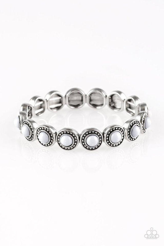 Paparazzi Accessories Globetrotter Goals - Silver Dotted with neutral gray beaded centers, studded silver frames are threaded along stretchy elastic bands and linked around the wrist for a whimsical look. Sold as one individual bracelet. Jewelry
