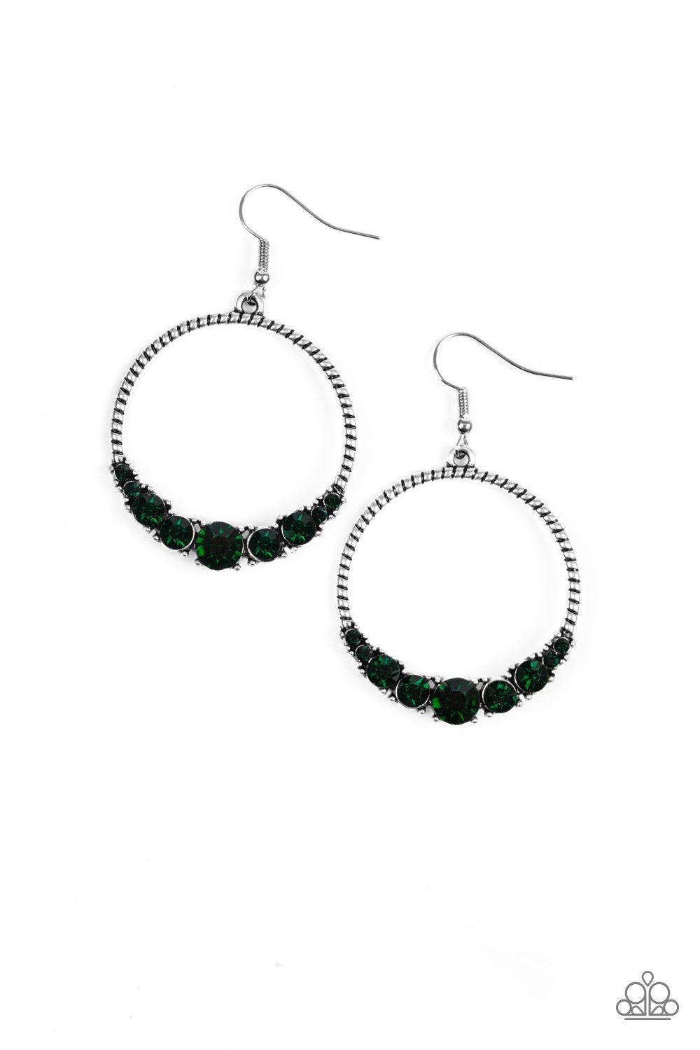 Paparazzi Accessories Self-Made Millionaire - Green The bottom of a textured silver hoop is encrusted in glittery green rhinestones for a glamorous look. Earring attaches to a standard fishhook fitting. Jewelry