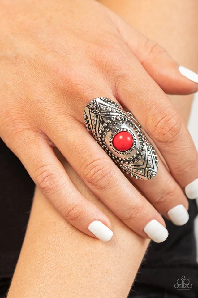 Paparazzi Accessories Rural Residence - Red A fiery red stone creates a colorful centerpiece for an oversized elongated silver frame. Embellished with studded texture and geometric designs, the patterned frame results in a hypnotizing lure atop the f