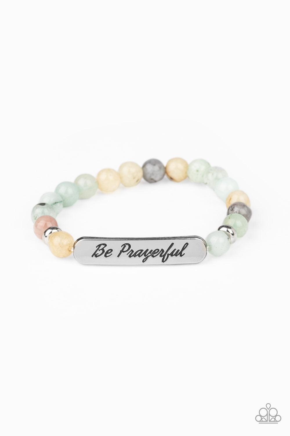 Paparazzi Accessories Be Prayerful - Green Infused with dainty silver accents, a collection of glassy stone beads and a shimmery silver frame stamped in the phrase, "Be Prayerful", are threaded along a stretchy band around the wrist for an inspirational l