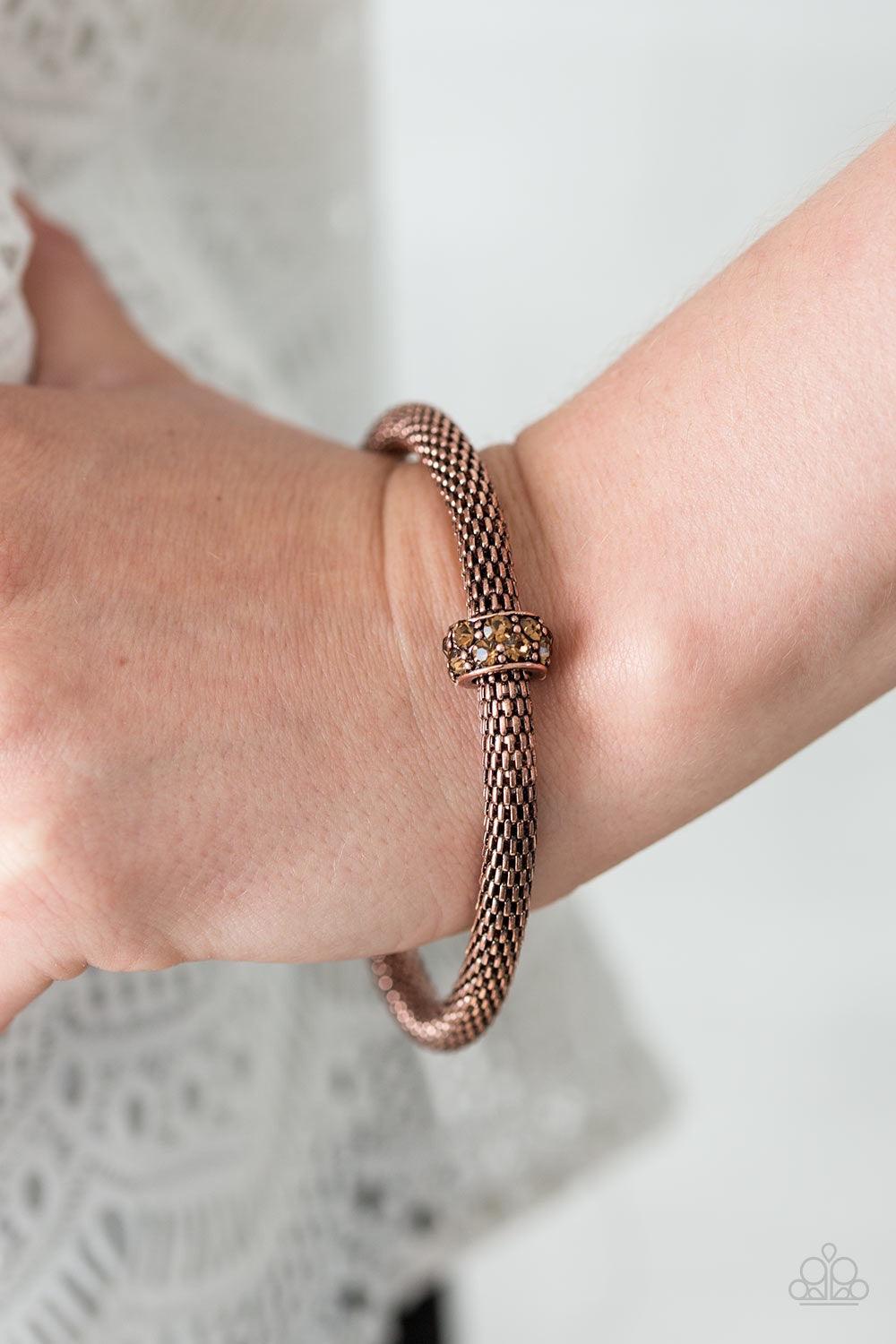 Paparazzi Accessories CACHE Or Card? - Copper Shimmery copper mesh chain joins into a thick bangle around the wrist. Encrusted in glittery topaz rhinestones, a copper ring slides along the bangle, adding sassy sparkle to the edgy palette. Jewelry