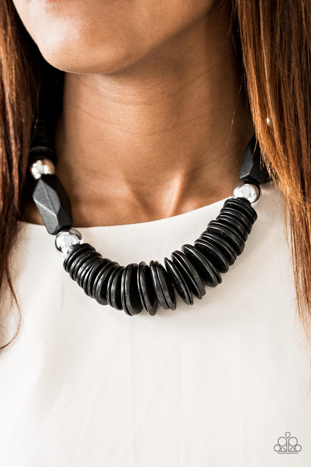 Paparazzi Accessories Boldly Belize - Black Brushed in a shiny black finish, round wooden discs are threaded along shiny brown cording, stacking below the collar for a seasonal look. Dramatic silver beads and faceted wooden accents join the earthy palette